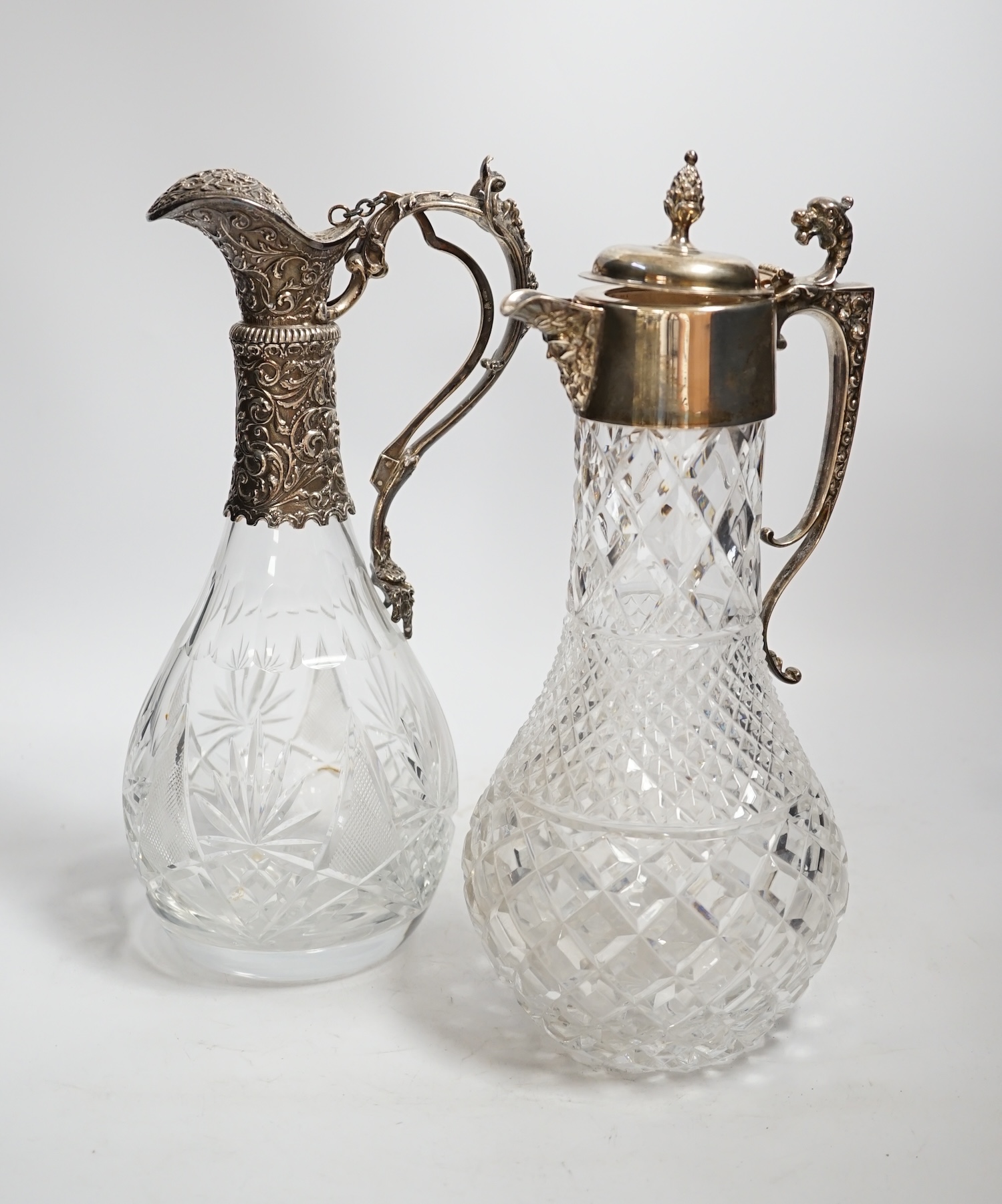 A 1970's silver mounted cut glass baluster claret jug, 31.3cm and one other 800 standard white metal mounted cut glass claret jug.